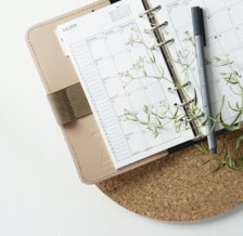 grey and black pen on calendar book